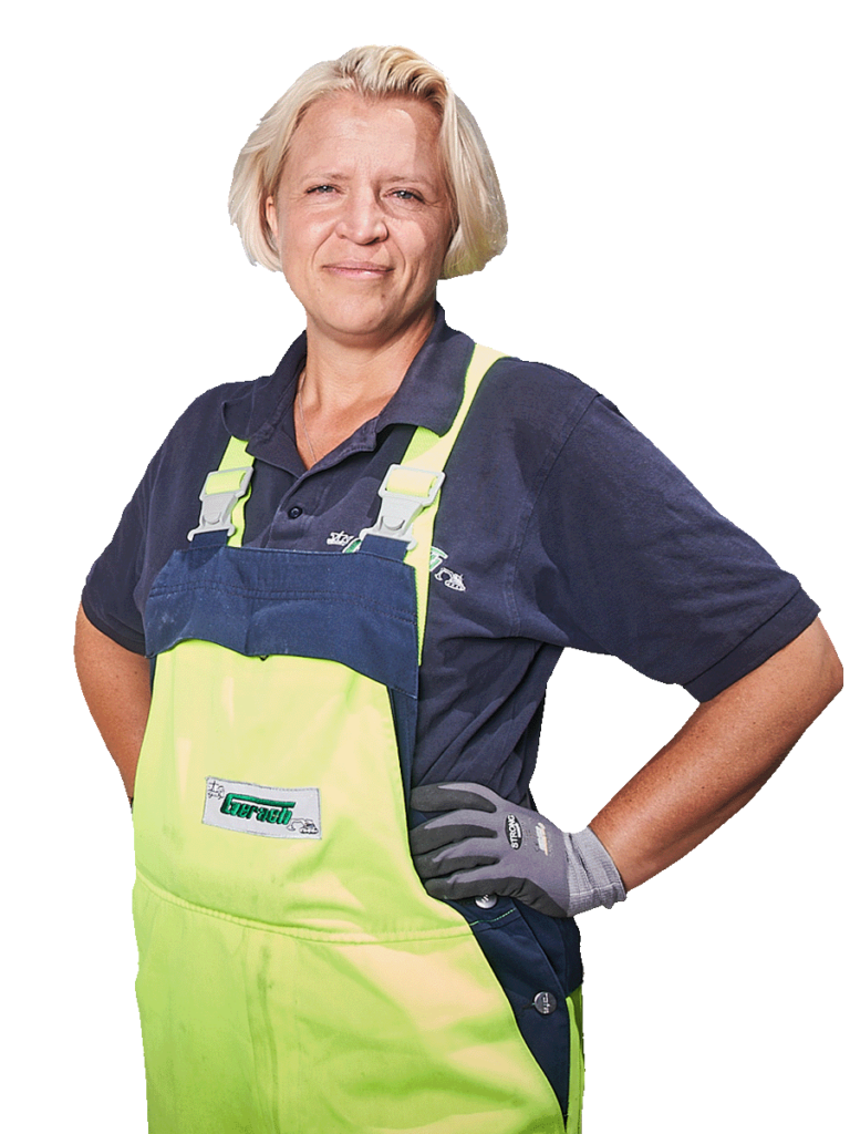 Lächelnde Frau in Arbeitskleidung
